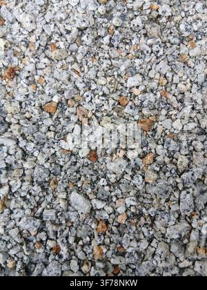 Small grey and white gravel stones texture background. Top view of clean natural crushed stones, pebbles, and grit. Perfect for paving or backdrop. Stock Photo