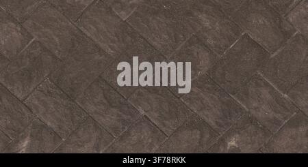 An overhead view of dark brown concrete paving tiles laid in a herringbone pattern. Stock Photo