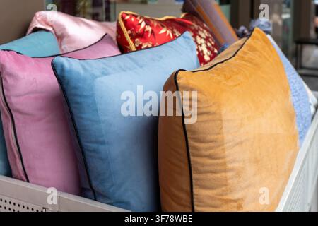 Colorful pillows arranged on retail display. Stock Photo
