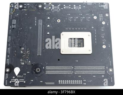 The back side of a black computer motherboard Stock Photo