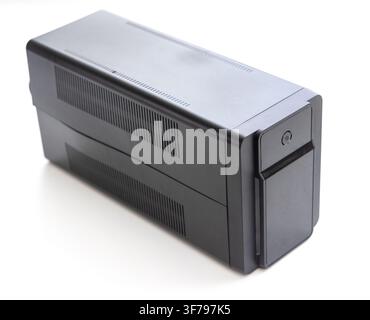 A black uninterruptible power supply device stands on white Stock Photo
