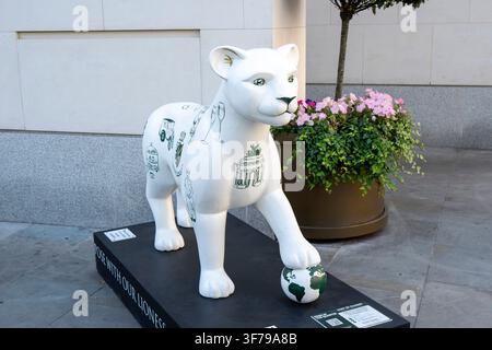 LONDON, UK - APRIL 08, 2026: Decorated white lioness sculpture standing on a display plinth with a globe under its paw as part of the Pride in the Qua Stock Photo