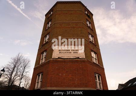 The 1892 Guinness Trust Buildings on Columbia Road, Hackney. These historic red-brick flats were built to provide social housing in London. Stock Photo