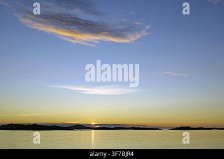 Calm sunset with bright colors on the horizon over a still sea, Hamn, Senja, Troms, Norway Stock Photo