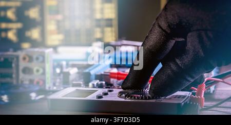 Technician hand in black protective glove adjusting multimeter dial. Computer hardware diagnostics and repair concept. Stock Photo