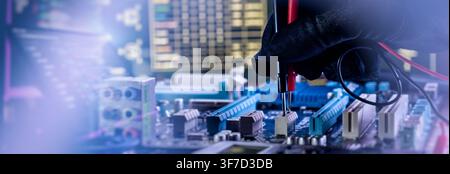Panoramic web banner of IT technician testing computer motherboard with multimeter probes. Hardware diagnostics concept with copy space. Stock Photo