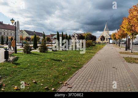 Gvardeysk, Russia- October 12, 2021: Atmospheric view of Victory Square in Gvardeysk, Kaliningrad Oblast: historic buildings, church spire, and dramat Stock Photo