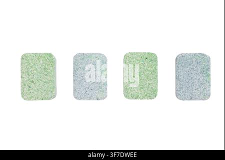 Colorful dishwasher detergent tablets in a row on white background closeup showing texture cleaning concept and household hygiene. Stock Photo