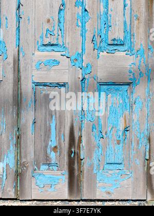 Painted wooden door surface damaged by salt air Stock Photo