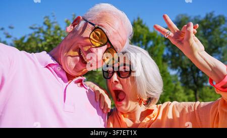 Senior couple making funny faces and v sign Stock Photo