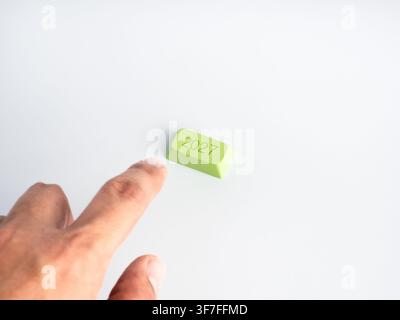 Finger approaches a green 2027 key on a clean white background with copy space. Future planning, strategic decisions, business activation, annual tran Stock Photo