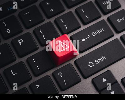 Red warning key on computer keyboard symbolizing cybersecurity threats, system alerts, malware detection, cyber attacks, security risks, critical erro Stock Photo