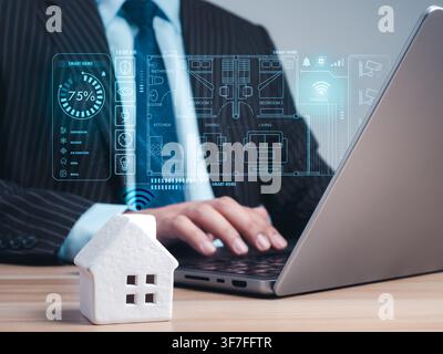 Business professional managing smart home system on laptop with digital dashboard, IoT connectivity, home automation, AI technology, energy management Stock Photo