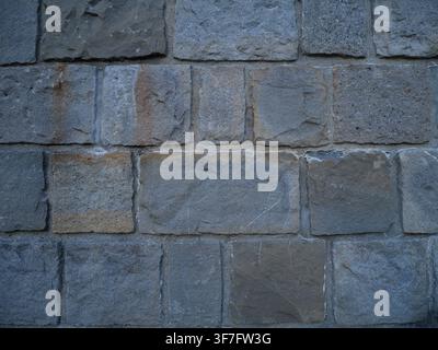 Large Grey Stone Block Wall Texture with Rough Weathered Surface, Rustic Masonry Background for Design and Architecture Projects. Stock Photo