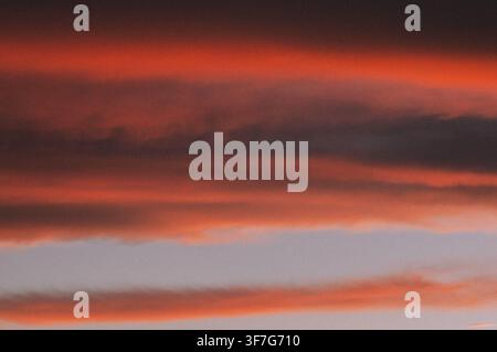 Fiery sunset clouds creating a vibrant evening sky Stock Photo