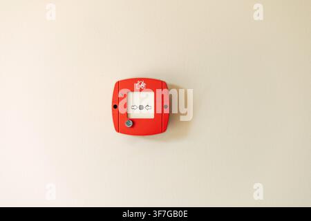 Red fire alarm button on wall Stock Photo