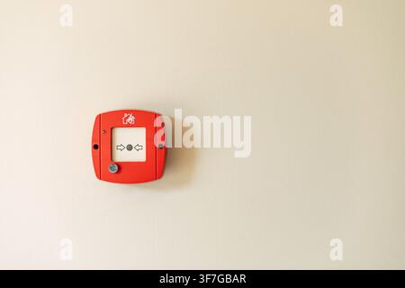 Red fire alarm button on wall Stock Photo