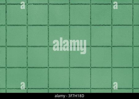 Green ceramic tile texture background with square pattern and subtle grunge surface. Abstract geometric wall backdrop with textured tiles and copy spa Stock Photo
