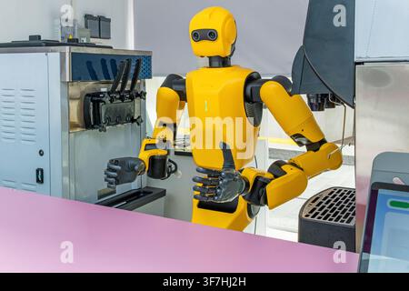 Humanoid robot preparing and serving cold drink at automated beverage station in Shenzhen, China. Artificial intelligence, robotics, service Stock Photo