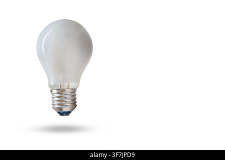 A light bulb hovers above a surface, casting a shadow on a plain white background. The bulb has a smooth surface and a standard metal base, without an Stock Photo