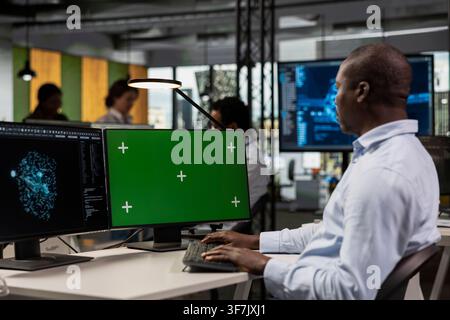 Green screen PC in AI startup office used by software developer building scalable solutions for businesses. Mockup computer used by IT expert in Silicon Valley workplace leveraging deep learning tech Stock Photo
