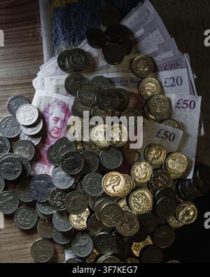Old British currency, including withdrawn pound coins and old £20/£50 banknotes. Stock Photo