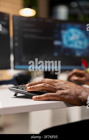 Close up of IT professional using AI chatbot to review code file for glitches. System administrator using artificial intelligence to suggest optimizations and speed up application performance Stock Photo
