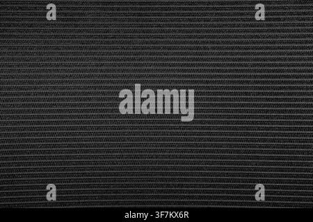 Black fabric texture with subtle horizontal stripes. Light reflects softly across surface. Ideal for backgrounds, design projects, or abstract visuals Stock Photo
