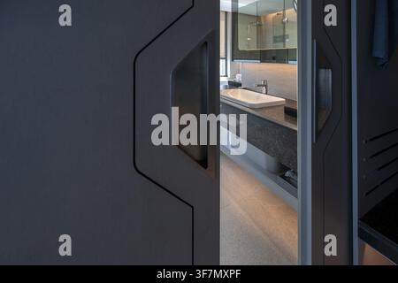 Hotel bathroom sliding door, sink and mirror, Pattaya, Thailand Stock Photo