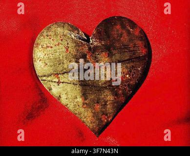 Rustic metal heart on a vibrant red background Stock Photo