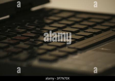 Close-up of a black laptop keyboard, focusing on the keys and creating a technological feel Stock Photo