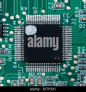 Macro of small microprocessor soldered printed circuit board. Stock Photo