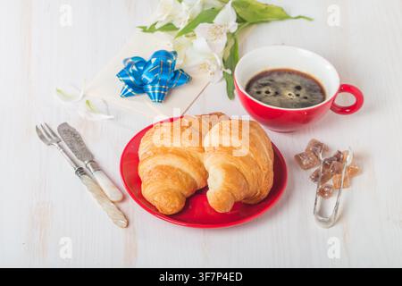 Fresh croissants with cup of hot coffee on white wooden background Stock Photo