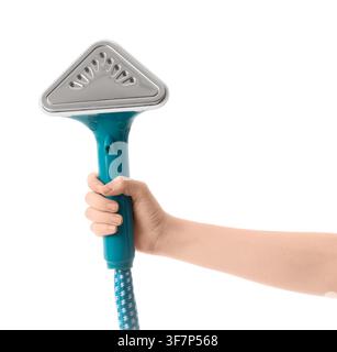 Womans hand holding a modern teal garment steamer with a patterned hose, isolated on a clean white background Stock Photo