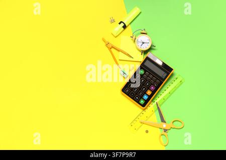 Composition with alarm clock, calculator and different school stationery on color background Stock Photo