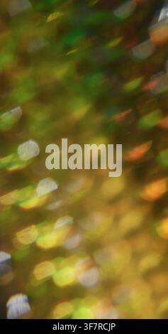 Defocused light spots. Yellow color flare. Radiant texture optical rainbow flash on abstract illuminated creative warm black bokeh background. Stock Photo