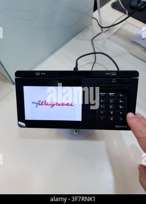 PLANO - JULY 20, 2026: A payment terminal displays the myWalgreens interface while a person interacts with it. Equinox terminals are used for secure t Stock Photo