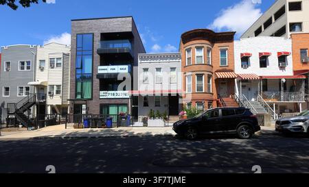 Multifamily residential buildings in a mishmash of architectural styles on a block west of Fourth Avenue in the Sunset Park, Brooklyn, New York Stock Photo