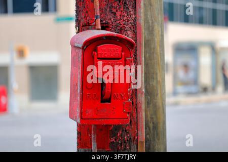 A FDNY fire alarm pull station on a street corner. Fire Department of New York. Stock Photo