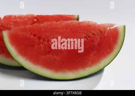 Fresh Slices of Red Watermelon Served on White Plate Stock Photo