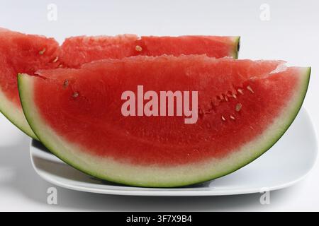 Fresh Slices of Red Watermelon Served on White Plate Stock Photo