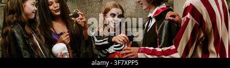 Header of Diverse Children in Halloween Costumes Eating Gummy Worms Stock Photo