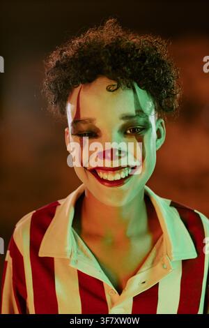 Portrait of Smiling Child in Clown Makeup Celebrating Halloween Stock Photo