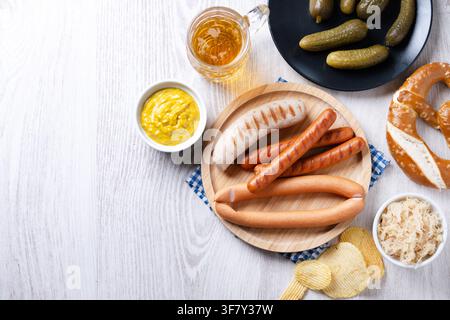 Traditional Oktoberfest food on white wooden table. Stock Photo