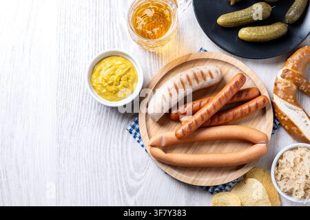 Traditional Oktoberfest food on white wooden table. Stock Photo