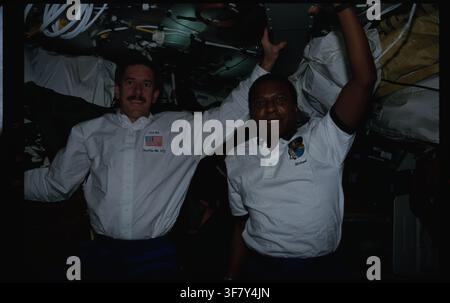 Astronauts Janet Reilly and Michael Anderson on board Spacehab during the STS-89 mission, with Reilly and Anderson holding to the ceiling. Stock Photo