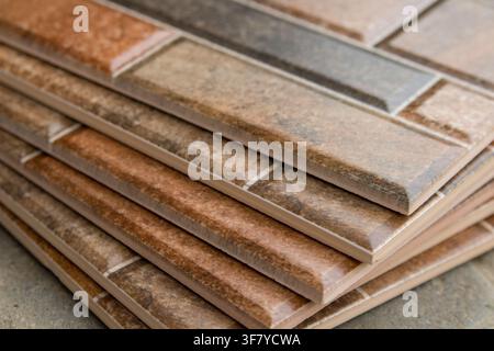 pile of brown ceramic tile wall for kitchen, ceramic tile wall brick background Stock Photo