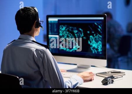 Man in Uniform Working at Security Control Room Computer Stock Photo