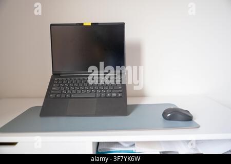 Laptop computer with wireless mouse on minimalist home office desk with copy space Stock Photo