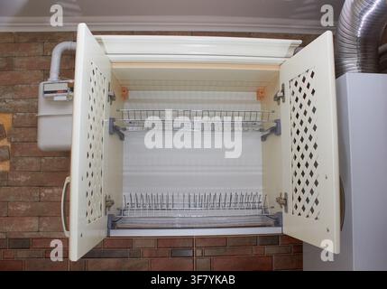 empty wall cabinet in the kitchen hangs on the wall for the dishes Stock Photo